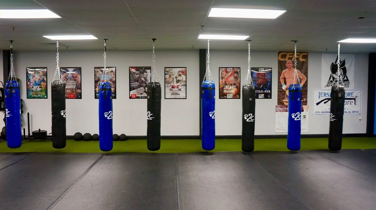 Training floor and punching bags at Sullivan Kickboxing Academy
