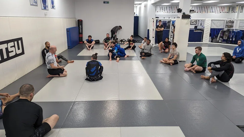 Adult instruction on Academy of Jiu-Jitsu mats
